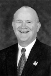 Dr. Nick Dunagan standing in a suit
